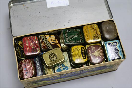 A large collection of gramophone needle tins and cleaning brushes, etc